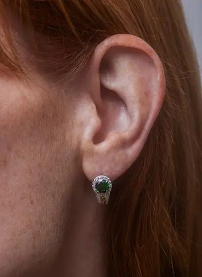 Close up of red haired woman wearing Sterling Silver Celtic Knot Halo Earrings with Green Cubic Zirconia